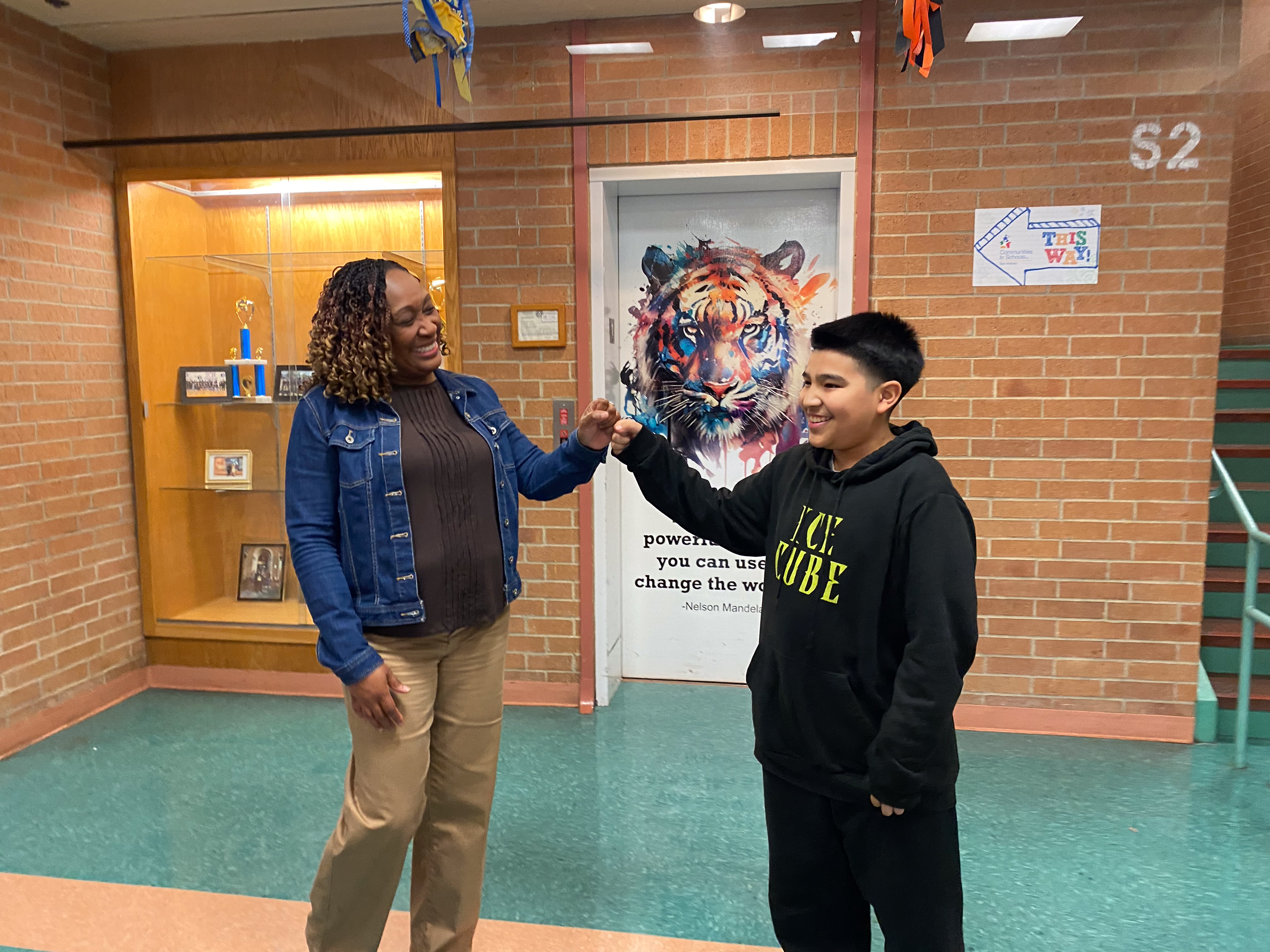 Ms. Adams fist bumps Poe student