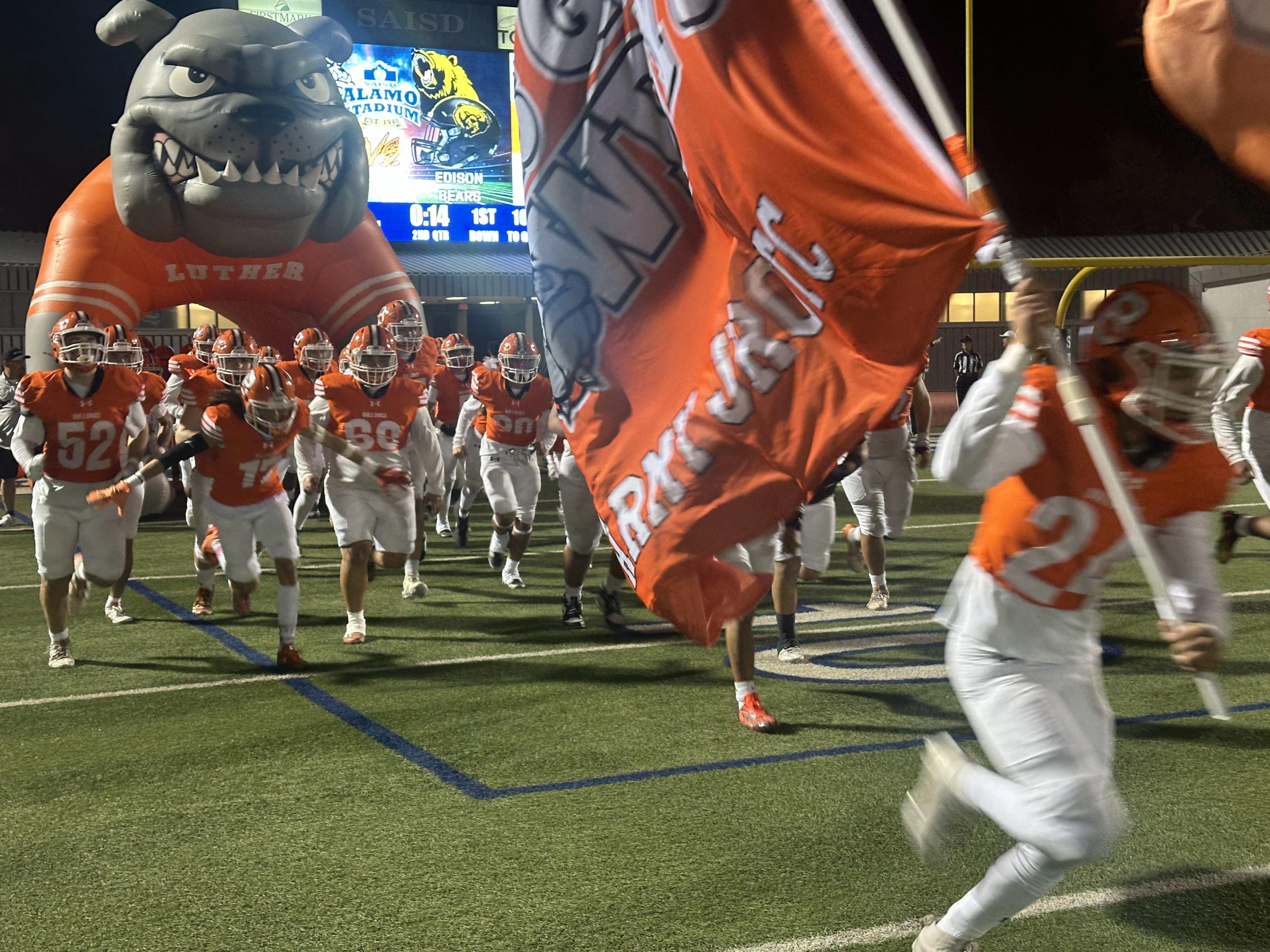 Burbank football runs with flag