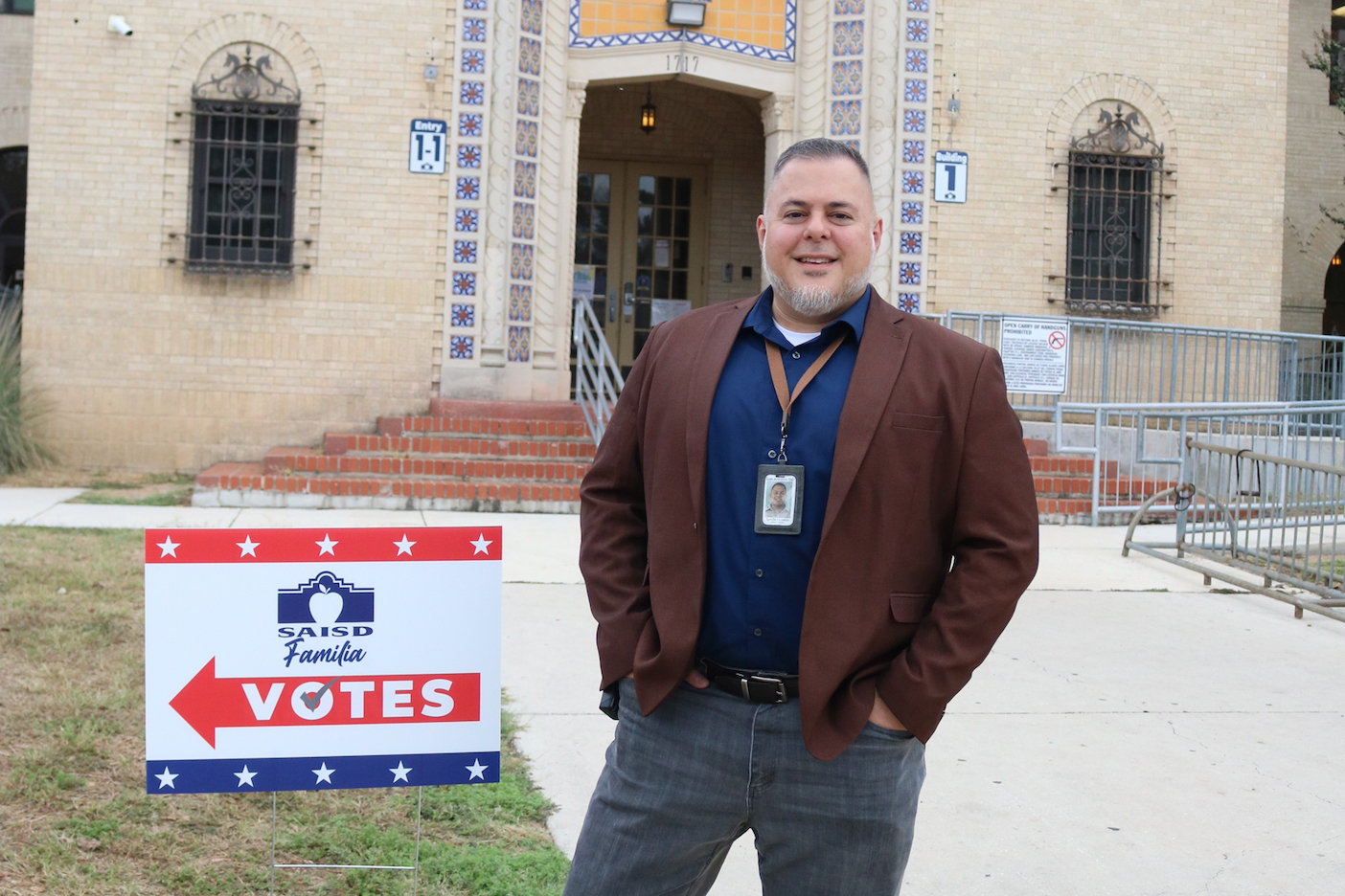 Principal De La Garza with voting sign