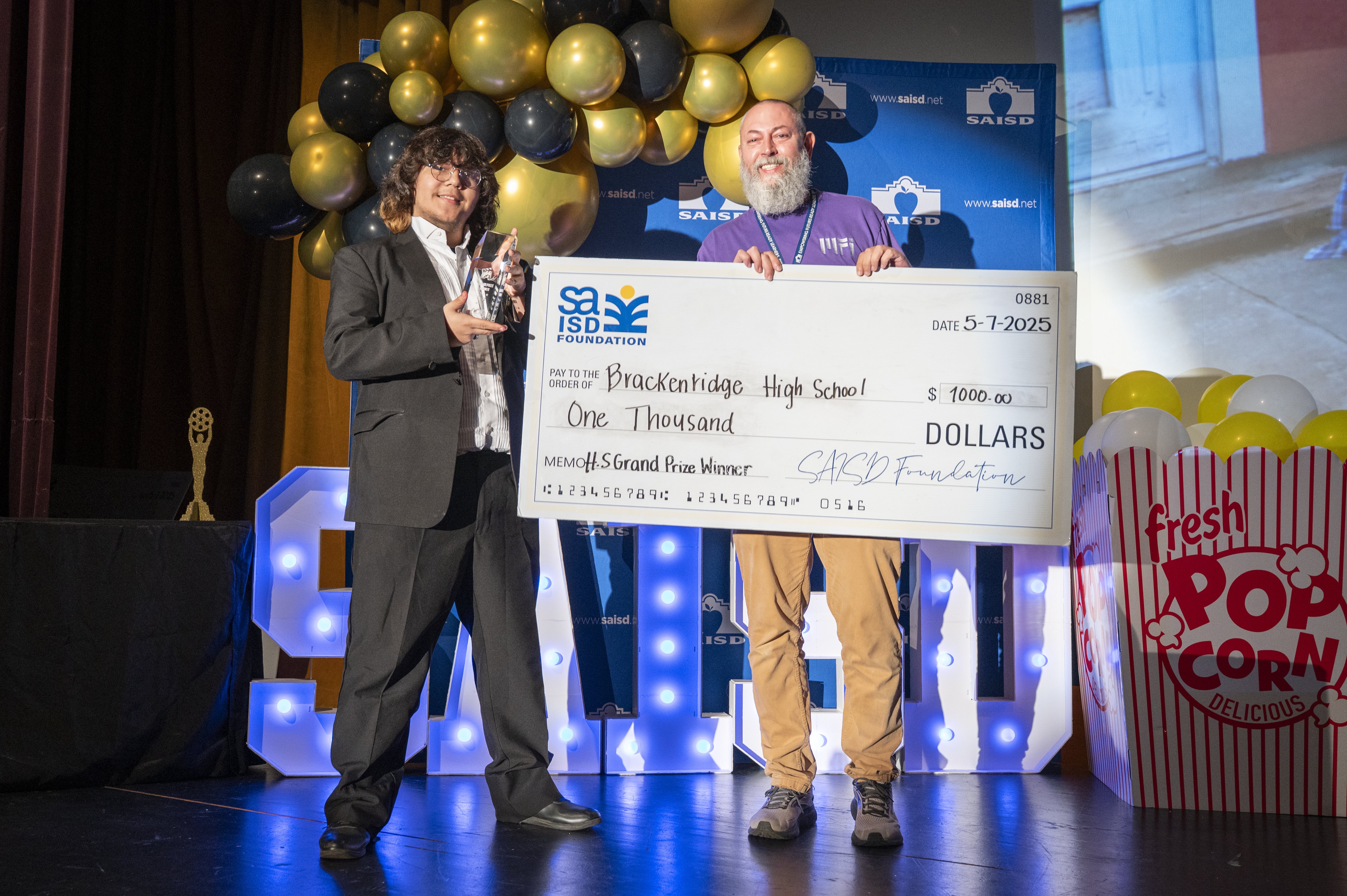 Winner high school holds check