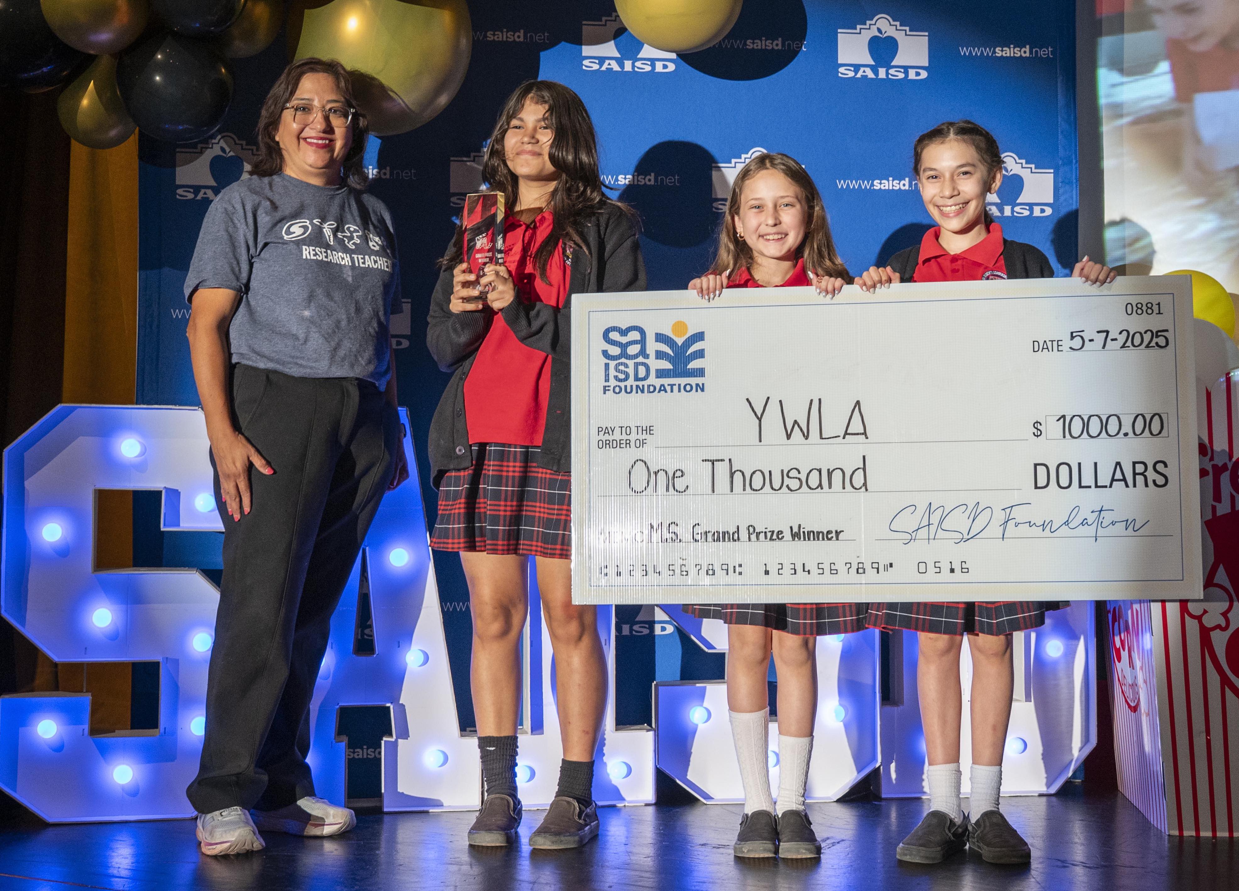 Winner middle school holds check