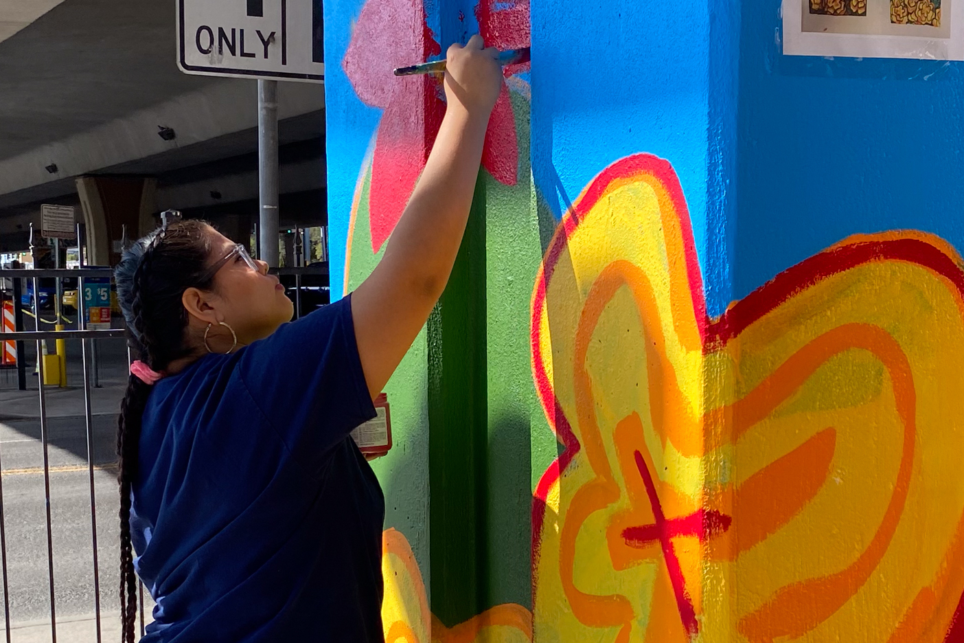 Student paints highway support pillar