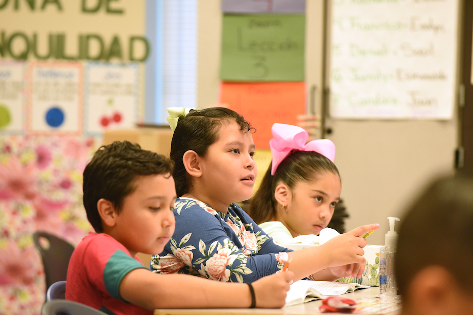Second grade dual language students at desk