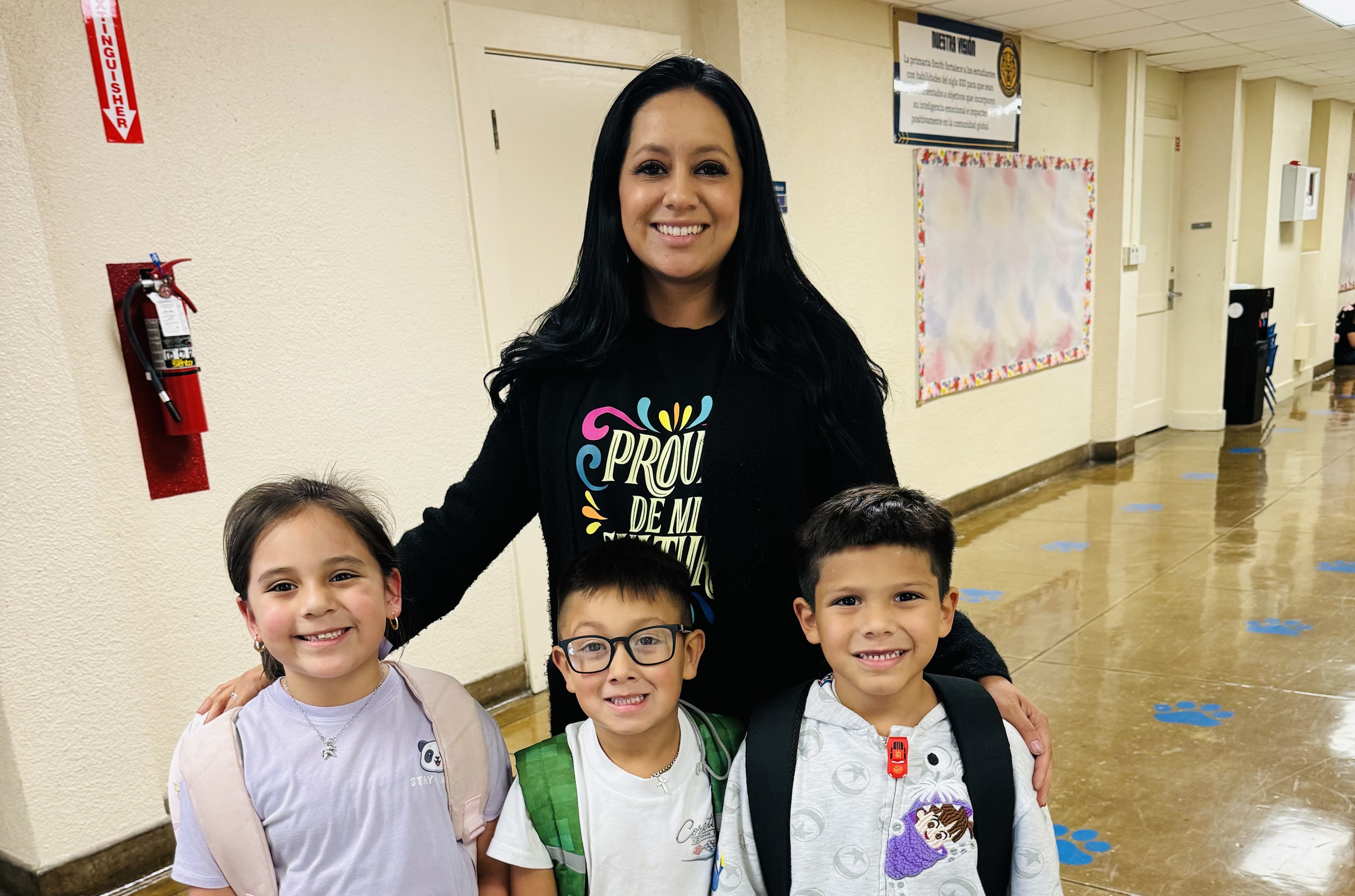 Ms. Rivera with students at dropoff