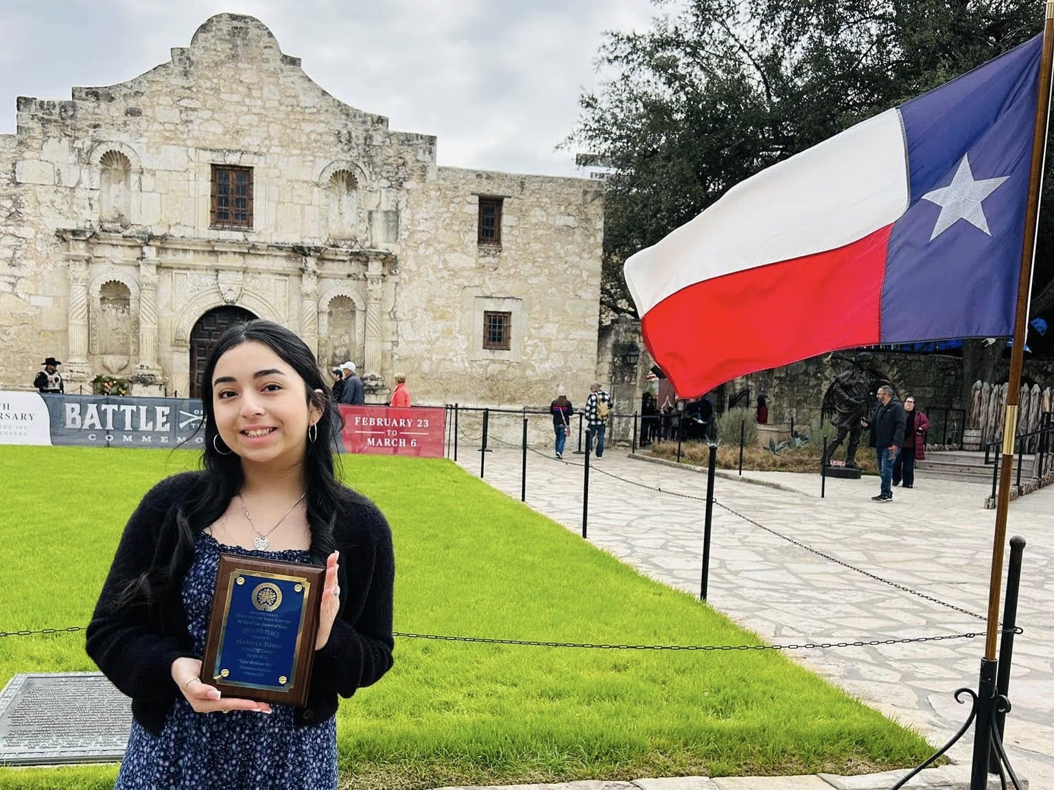 Makayla holds prize in front of Alamo