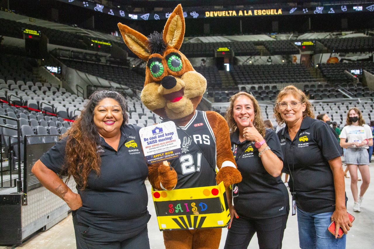 Spurs back to School Event Sign says Be Cool and keep SAISD moving! Now Hiring Bus Drivers (starting rate $16.75 an hour) $1,000 CDL & $500 non CDL incentives  Apply Now www.saisd.net 210-354-9313 