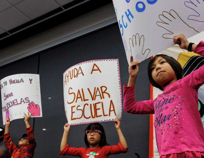 Children holding signs at SAISD Nov. 13 board meeting