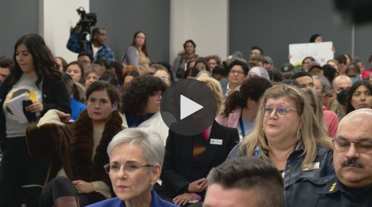 People sitting in the audience at a SAISD board meeting