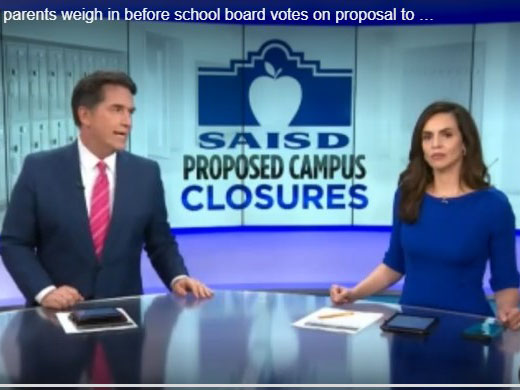 Anchors in front of screen of SAISD logo