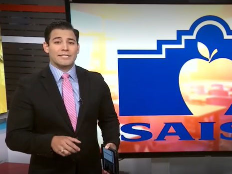 KSAT anchor in front of SAISD logo