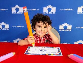 Young boy with giant pencil