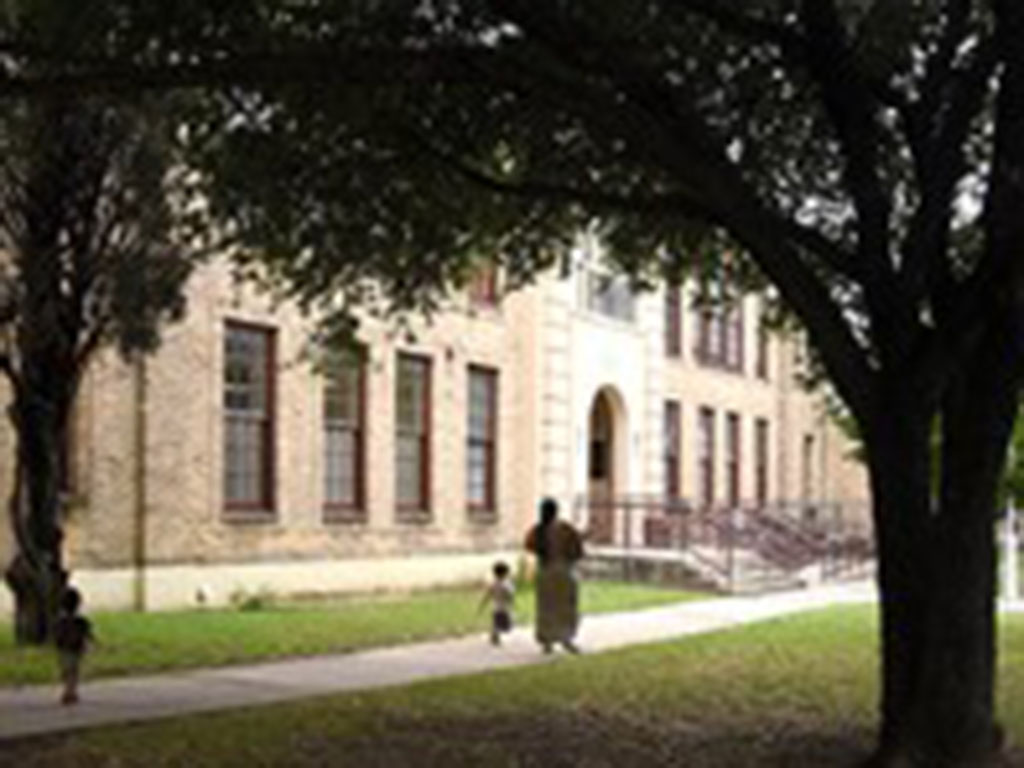 A mom walks a child to school