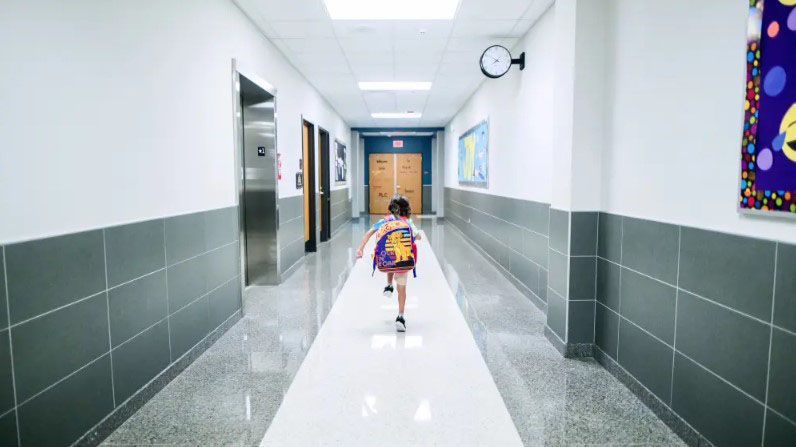 Child running down a hallway