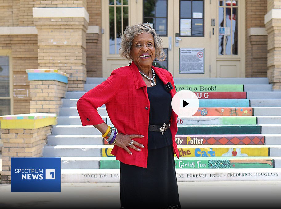Gloria Ray  standing in front of Douglass Elementary
