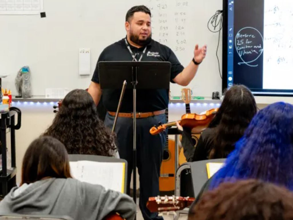 Mariachi teacher in front of class