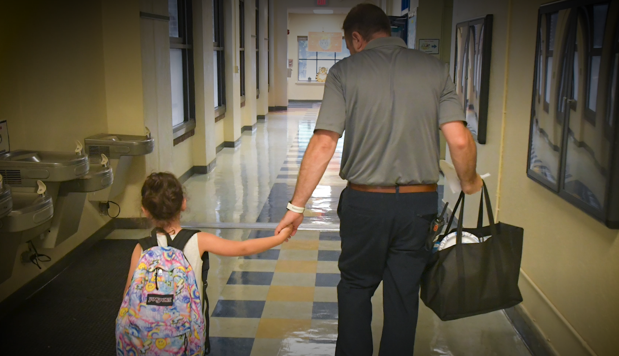 father and daughter in school hallway